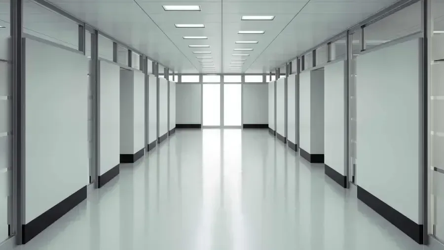Empty, bright hallway leading to a bright window at the end.