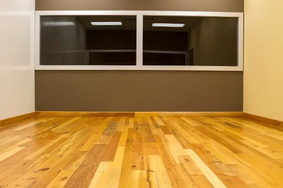 Empty, bright hallway leading to a bright window at the end. Empty, bright hallway leading to a bright window at the end.